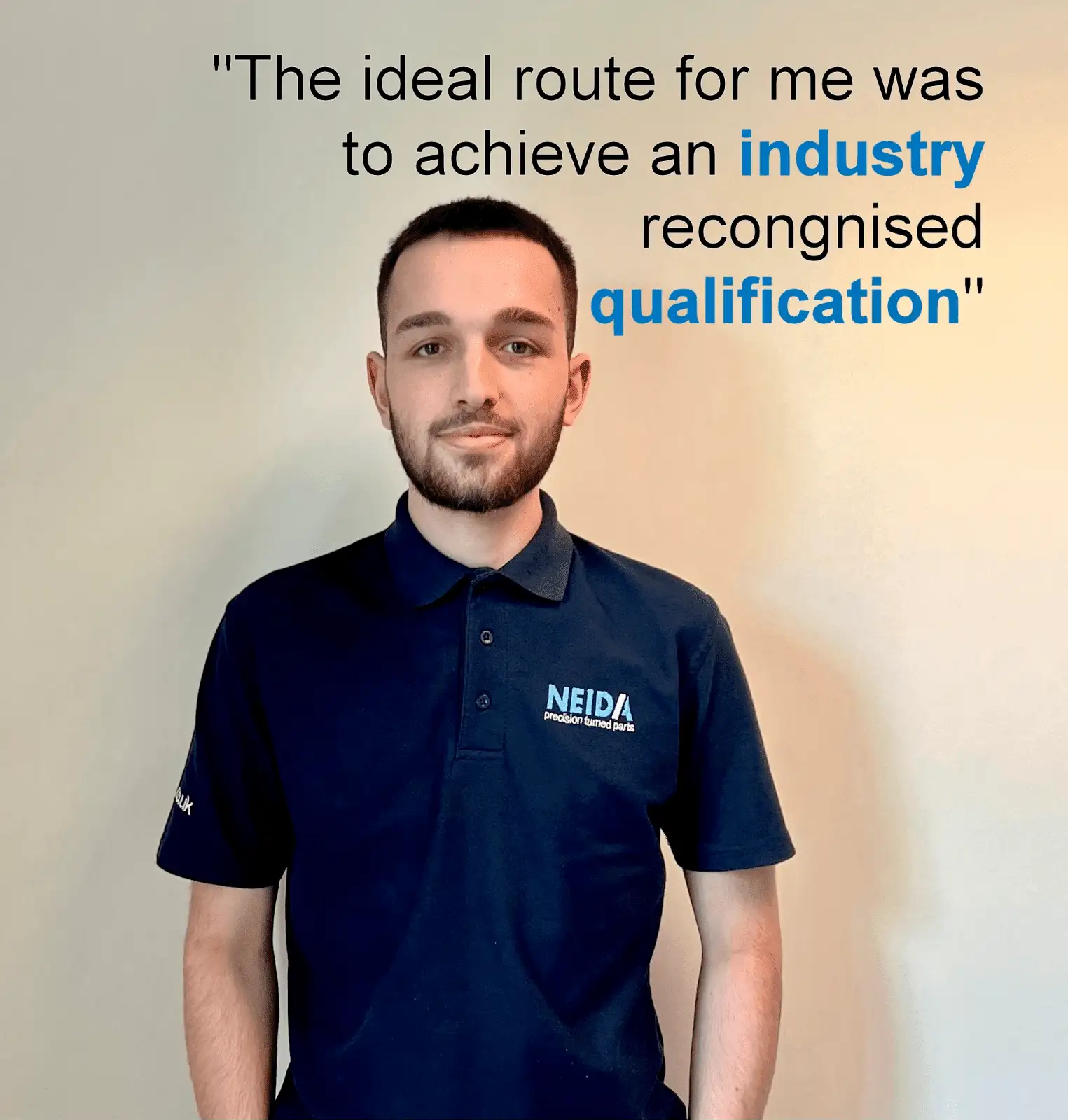 An apprentice wearing a work uniform, standing confidently next to a clean white wall. The apprentice appears determined and focused on their career goals. In the image, the quote 'The ideal route for me was to achieve an industry-recognized qualification' is displayed in stylish typography, highlighting the apprentice's belief in obtaining a respected certification that is widely recognized within their industry.